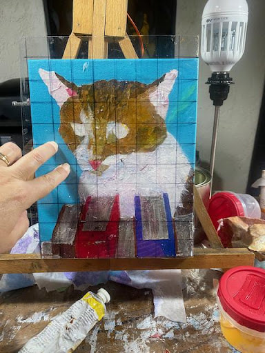 holding-clear-grid-against-painting-to-check-drawing-painting-by-Angeline-Marie-Martinez